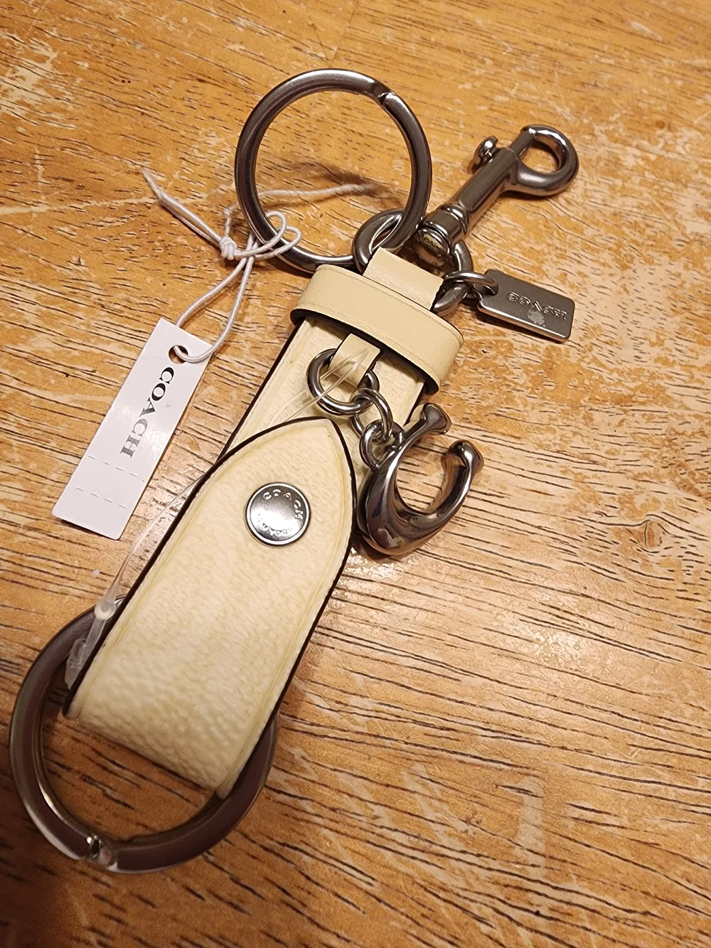Coach Trigger Snap Bag Charm in Signature Canvas featuring a sleek Beige/silver